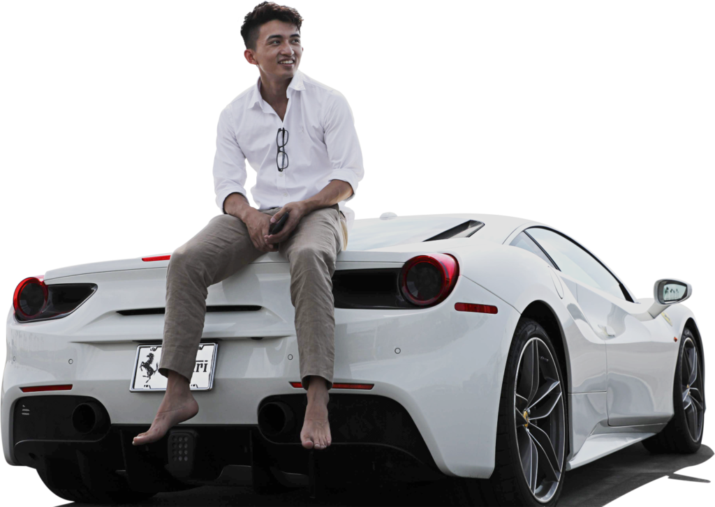 Steven Dux sitting on the back of a white Ferrari